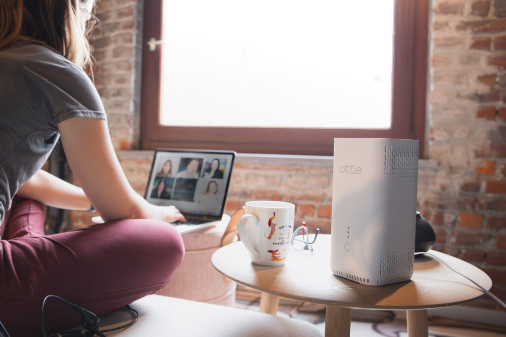 A woman doing hybrid work participates in a conference call using Ottie. Ottie keeps you connected, even if your broadband goes down.